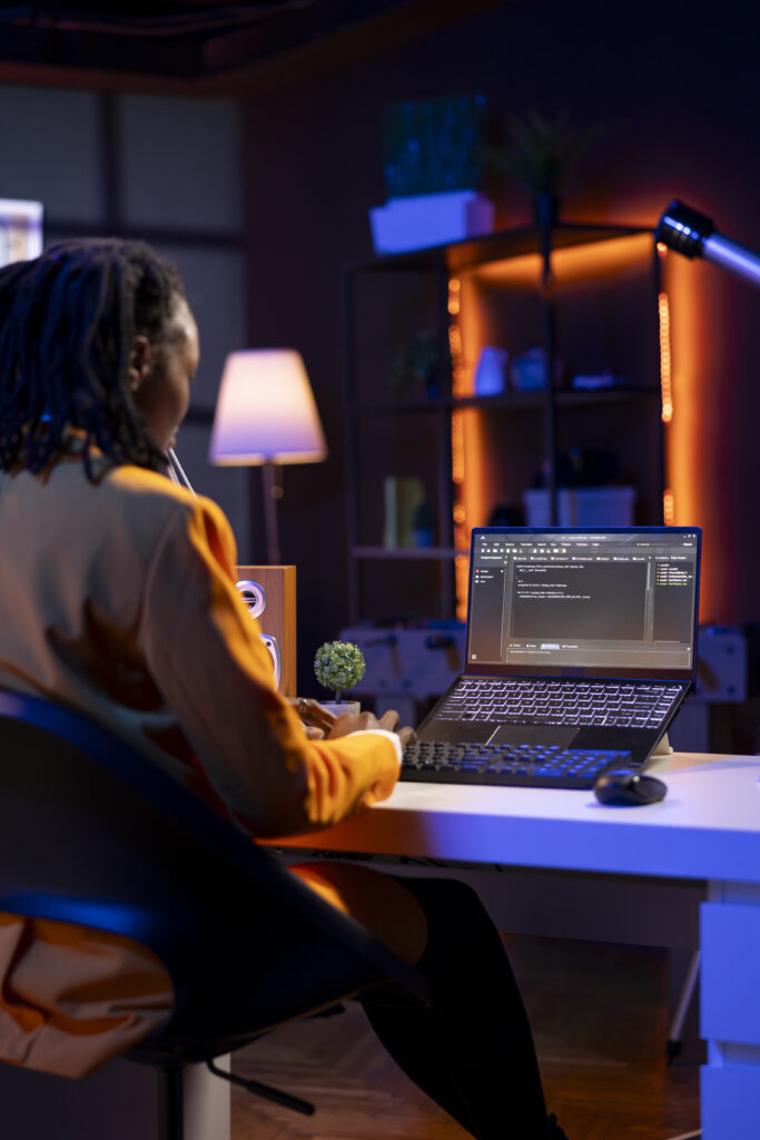 Team technician in home office typing code on notebook device